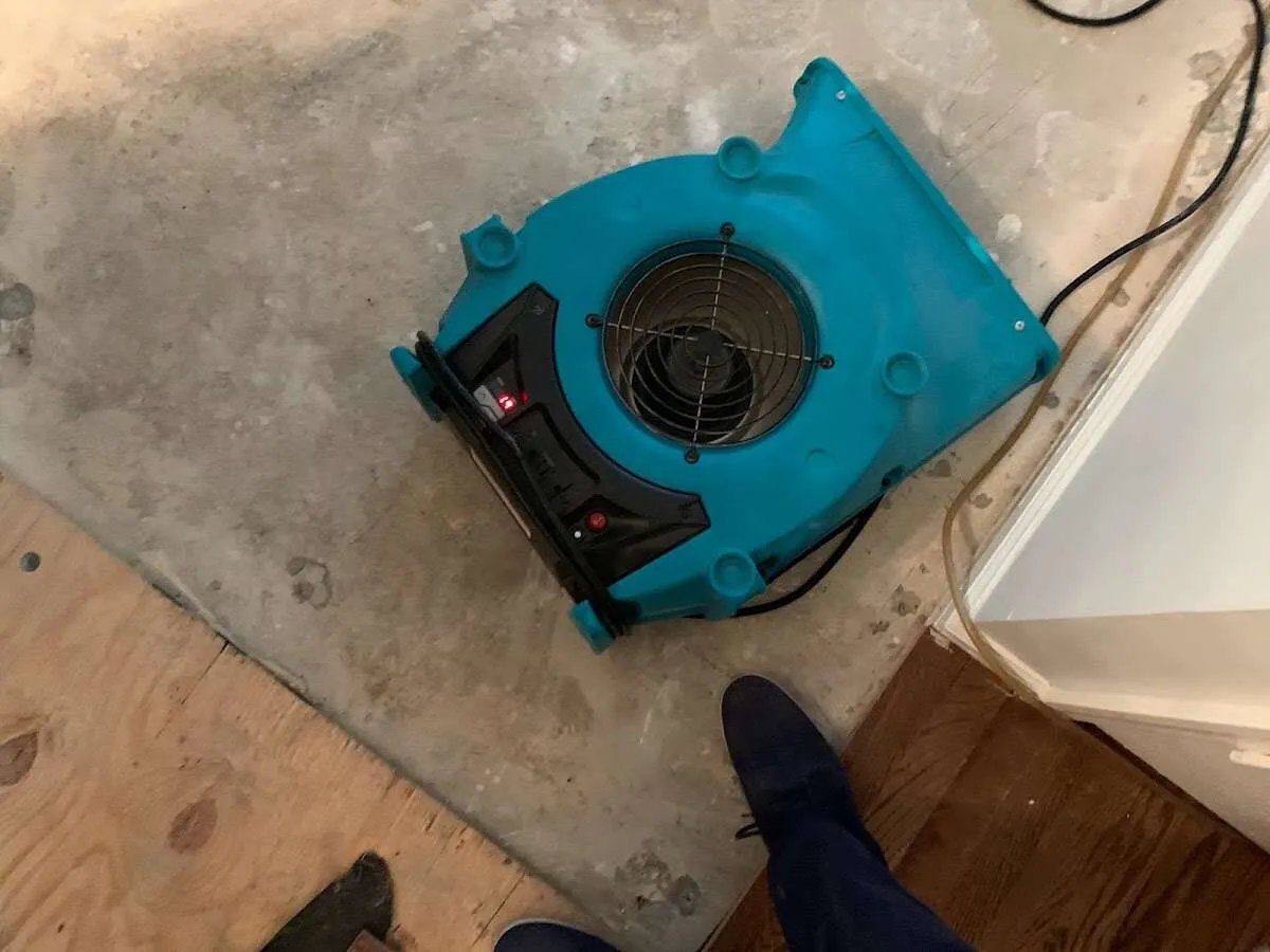 Air mover drying subfloor during Commercial Water Damage Restoration in Lakes of the Four Seasons
